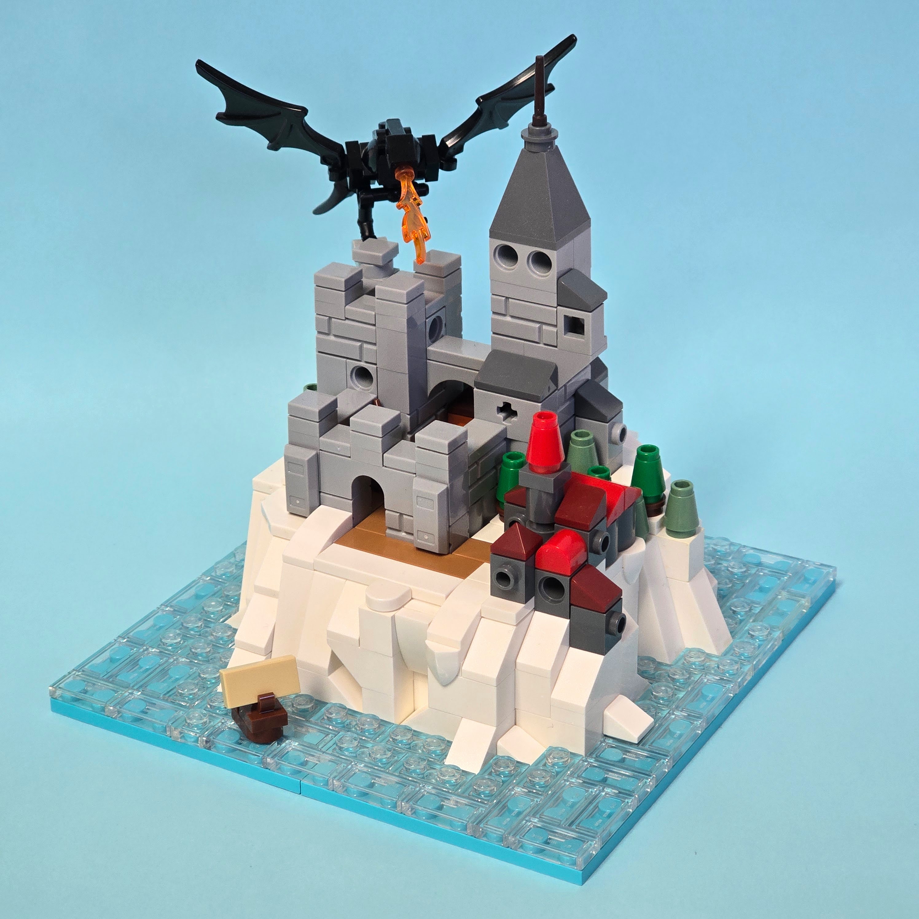 Microscale Lego castle in an icy sea being attacked by a dragon, created by Alex Lyman