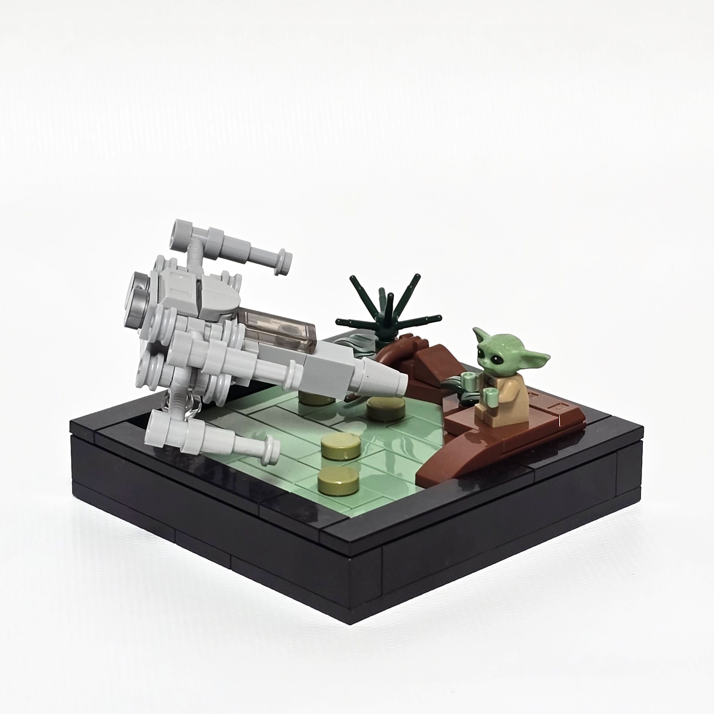Lego Yoda lifting Luke's X-wing out of the Dagobah swamp, created by Alex Lyman